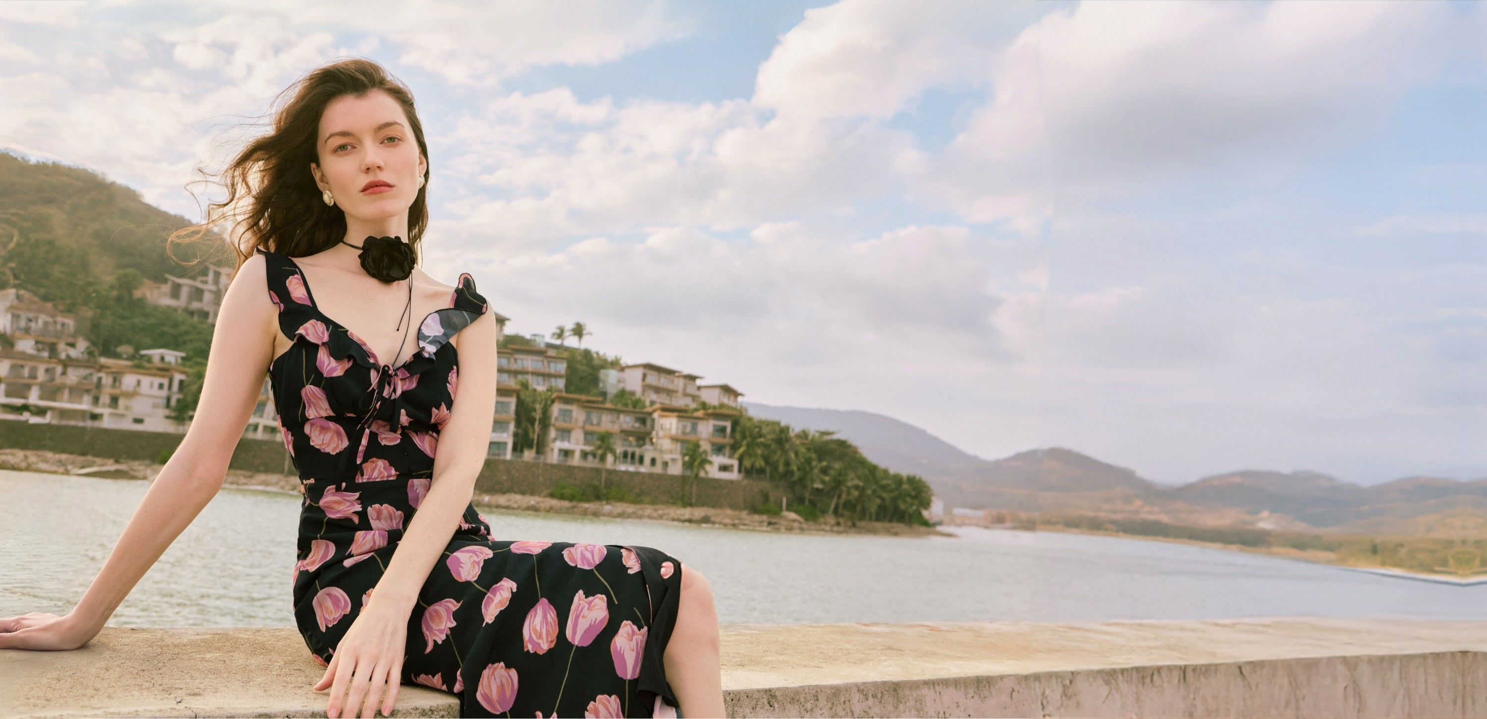 Petite model laying by the beach in Petite Studio dress